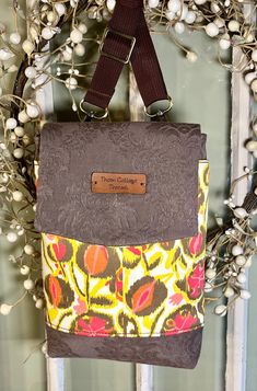 You will love using this crossbody bag for its eye-catching looks and comfortable fit!   The up cycled brown damask is offset with an artsy floral in coral, yellow and brown. Opening the flap's magnetic snap reveals an outer front compartment with  two card pockets that can each easily hold 6-8 cards. The pockets are made of Faraday fabric that will keep your card information secure. The roomy main compartment has one slip pocket and plenty of room for  your essentials. Even your Kindle! The bac Everyday Brown Upcycled Shoulder Bag, Daily Use Brown Upcycled Shoulder Bag, Brown Upcycled Shoulder Bag For Daily Use, Brown Upcycled Bag For Everyday Use, Brown Upcycled Bags For Everyday Use, Brown Upcycled Crossbody Shoulder Bag, Travel Brown Upcycled Shoulder Bag, Cell Phone Bag, Bag Handmade