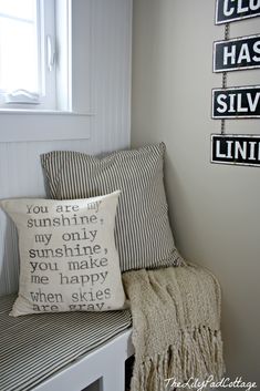 a bench with pillows and signs on the wall