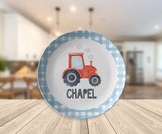 a blue and white plate with a red tractor on it that says chapel