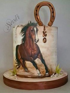 there is a cake with a horse on it and a wooden handle in the shape of a bag