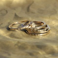 three wedding rings sitting on top of each other