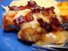 a close up of food on a blue plate with a fork and utensil