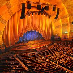 an auditorium filled with lots of people sitting in seats