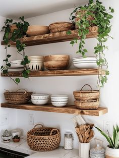 the shelves in the kitchen are filled with bowls and baskets, plants, and other items