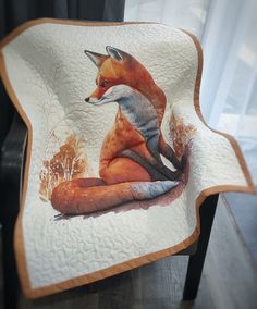 a plate with a painting of a fox sitting on it's side and its tail curled up