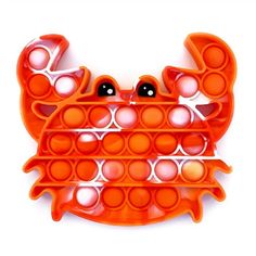 an orange crab shaped object with lots of holes in it's body and eyes