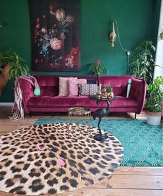 a living room with green walls and leopard print rug