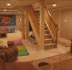 a living room filled with furniture and a stair case