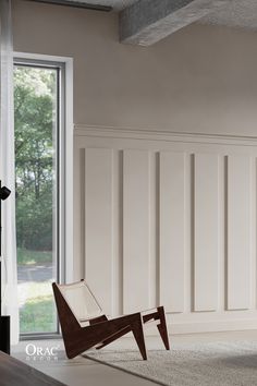 a chair sitting on top of a wooden floor in front of a sliding glass door