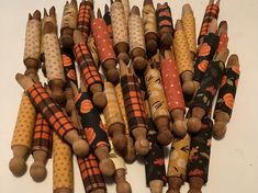 a bunch of wooden sticks with different designs on them and some are lined up together