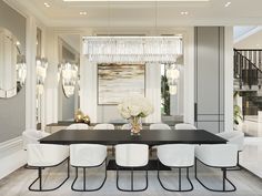 a dining room table with white chairs and chandelier