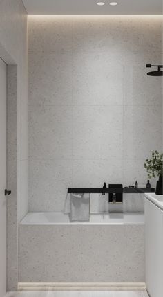 a bathroom with a bathtub, sink and towel rack in the middle of it