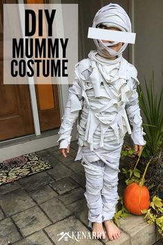 a young child wearing a costume made out of newspaper strips and duct tape with text overlay reading diy mommy costume