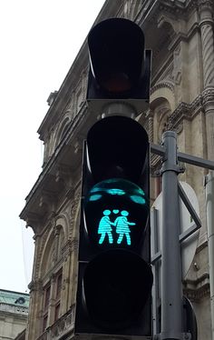 a traffic light with a green pedestrian crossing signal