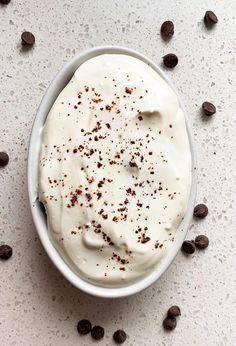 a bowl filled with whipped cream surrounded by chocolate chips