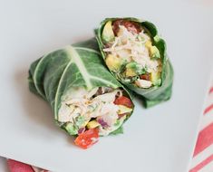 two wraps filled with chicken and vegetables on a white plate