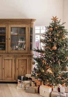 a living room with a christmas tree and presents on the floor