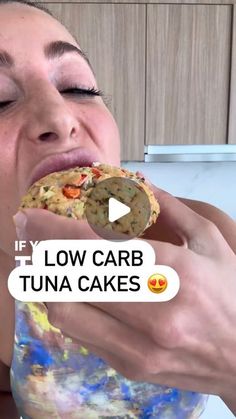 a woman holding a cookie up to her face with the caption low carb tuna cakes