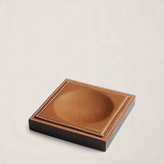 two brown plates sitting on top of each other