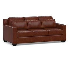 a brown leather couch sitting on top of a white floor