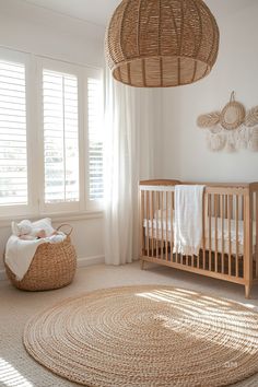 Cozy nursery with natural tones, featuring wicker decor, a rattan light fixture, neutral crib, and a round woven rug. Ideal for nursery inspo. Farmhouse Boho Nursery, Nursery Natural Earthy, Cozy Cottage Nursery, Nursery Ideas Western, Cottagecore Nursery Ideas, Vintage Boy Nursery Ideas, Western Baby Room, Natural Nursery Ideas, Farmhouse Baby Nursery