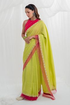 Lime green chanderi saree with floral embroidery and a scalloped border. Paired with a pink halter neck blouse.
Components: 2
Pattern: Embroidered
Type Of Work: Hand and machine embroidery
Neckline: Halter
Sleeve Type: Sleeveless
Fabric: Chanderi
Color: Green
Other Details: 
Back cutout tasseled blouse
Occasion: Mehendi and Haldi - Aza Fashions Green Slub Silk Pre-draped Saree For Diwali, Green Chanderi Pre-draped Saree For Festivals, Green Pre-draped Saree With Gota Work For Eid, Semi-stitched Green Chanderi Choli, Festive Pista Green Chanderi Pre-draped Saree, Designer Green Chanderi Choli, Green Chanderi Choli For Navratri, Traditional Sleeveless Pre-draped Saree With Pallu, Green Resham Embroidered Cotton Silk Blouse Piece