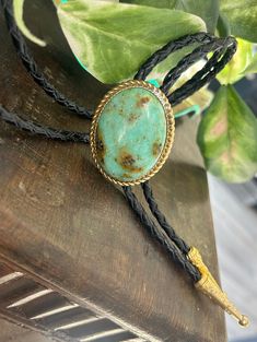 "This awesome bolo tie has a southwestern design and turquoise colored agate centerpiece. All stones are different. The cord is genuine black leather and it has gold metal detailing. Our bolos pair nicely with many of our belt buckles! They make wonderful gifts.    The western bolo tie rope length is 100cm(39\") ; charm agate stone pendant size is 5*4cm(1.97*1.57in)" Adjustable Oval Jewelry With Patina, Handmade Adjustable Bolo Ties For Festivals, Handmade Festival Bolo Ties, Adjustable Green Southwestern Jewelry, Southwestern Lariat Turquoise Necklace, Southwestern Adjustable Lariat Turquoise Necklace, Southwestern Adjustable Turquoise Lariat Necklace, Adjustable Southwestern Turquoise Lariat Necklace, Southwestern Style Adjustable Bolo Ties