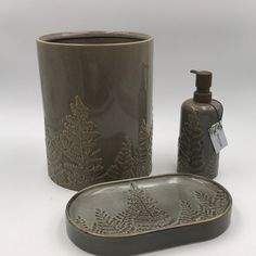 a bathroom set consisting of a soap dispenser, dish and cup