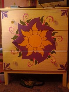 a dresser with an artistic design painted on it