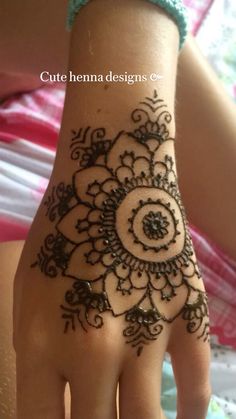 a woman's hand with henna on it