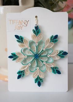 an origami snowflake is displayed on a card with the tag tiffany joy