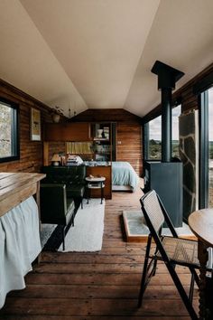 a living room filled with furniture next to a wooden floor covered in lots of windows