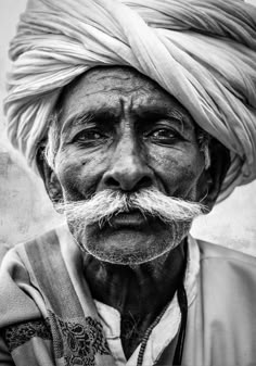 an old man with a moustache on his head