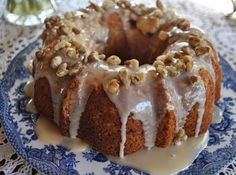 a bundt cake on a blue and white plate with icing drizzled