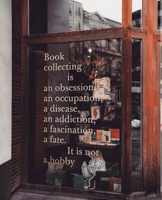 an advertisement in a shop window on the side of a building that says book collecting is an occasion