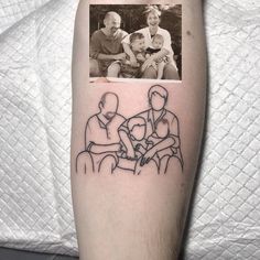 a family tattoo on the left arm with an image of two adults and a child