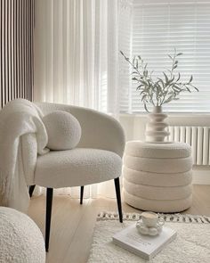 a white chair and ottoman in a room