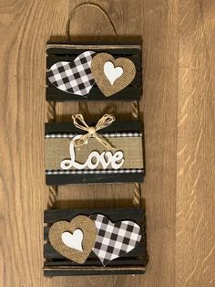 three pieces of wood with hearts on them