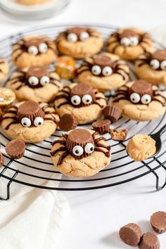 cookies decorated with googly eyes and chocolate chips on a cooling rack, ready to be eaten