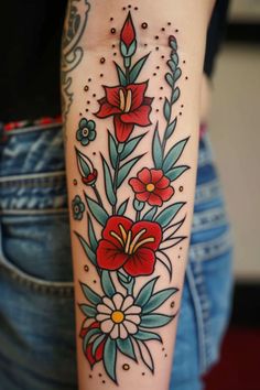 a woman's arm with flowers and leaves tattooed on the side of her body