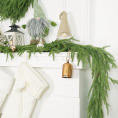 stockings hanging on the mantle with christmas decorations