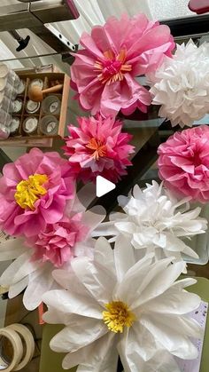 pink and white paper flowers in a vase