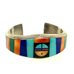 Vintage Artisan Multi Stone Cuff Bracelet- Beautifully made by Navajo artist Frank Yellow Horse - piece is signed- Marked "Sterling"- Substantial heavy rigid cuff- Multi stone inlay of turquoise, malachite, lapis lazuli, spiny oyster, onyx- Inlay Sun God in center of cuff- The width of the cuff varies throughout, widest at ends and in center. Center width about 1"- Cuff measures 5" end to end with an opening of just under 1"- Cuff weighs 68.9g- Cuff is in good vintage condition, with patina to t Yellow Horse, Turquoise Cross Pendant, Stained Glass Rose, Glass Rose, Sun God, Turquoise Cross, Turquoise Ring Silver, Stone Inlay, Spiny Oyster