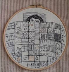 an embroidery project with a woman's face and arms in the shape of a blanket