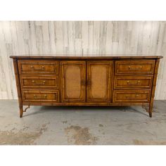 an old dresser with wicker doors and drawers