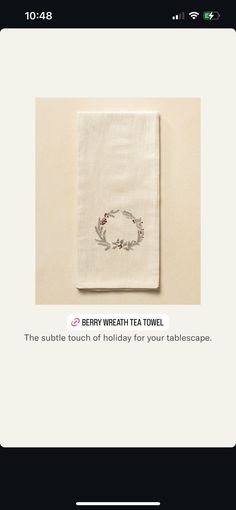 the screen has an image of a tea towel with a wreath on it, and text that reads berry wheat tea towel