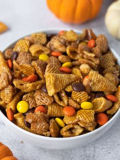 a white bowl filled with cereal and candy cornflakes on top of a table