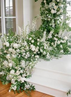 white flowers and greenery are on the steps