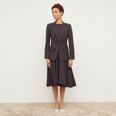 Made from breathable, machine-washable wool twill, the Gabriella dress holds you in without feeling too tight. It features a boatneck, slight high-low hemline, and strategically placed seams designed to hit in all the right places. A subtle A-line shape and godet-style panels in the skirt create movement and give you room through the hips. Structured Fitted Midi Dress For Fall, Fitted Structured Midi Dress For Fall, Tailored Midi Dress For Semi-formal Fall Events, Tailored Midi Dress For Fall, Structured Workwear Dresses For Fall, Structured Fall Workwear Dresses, Fall Workwear Dresses With Asymmetrical Hem, Fall Structured Workwear Dresses, Fitted Midi Dress For Business Casual In Fall