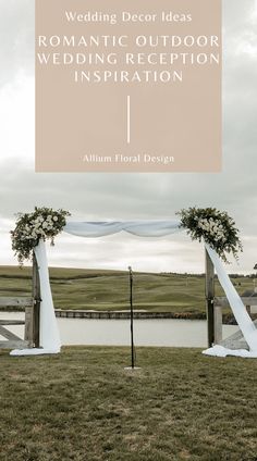 an outdoor wedding reception with white draping and flowers on the arch, in front of a lake